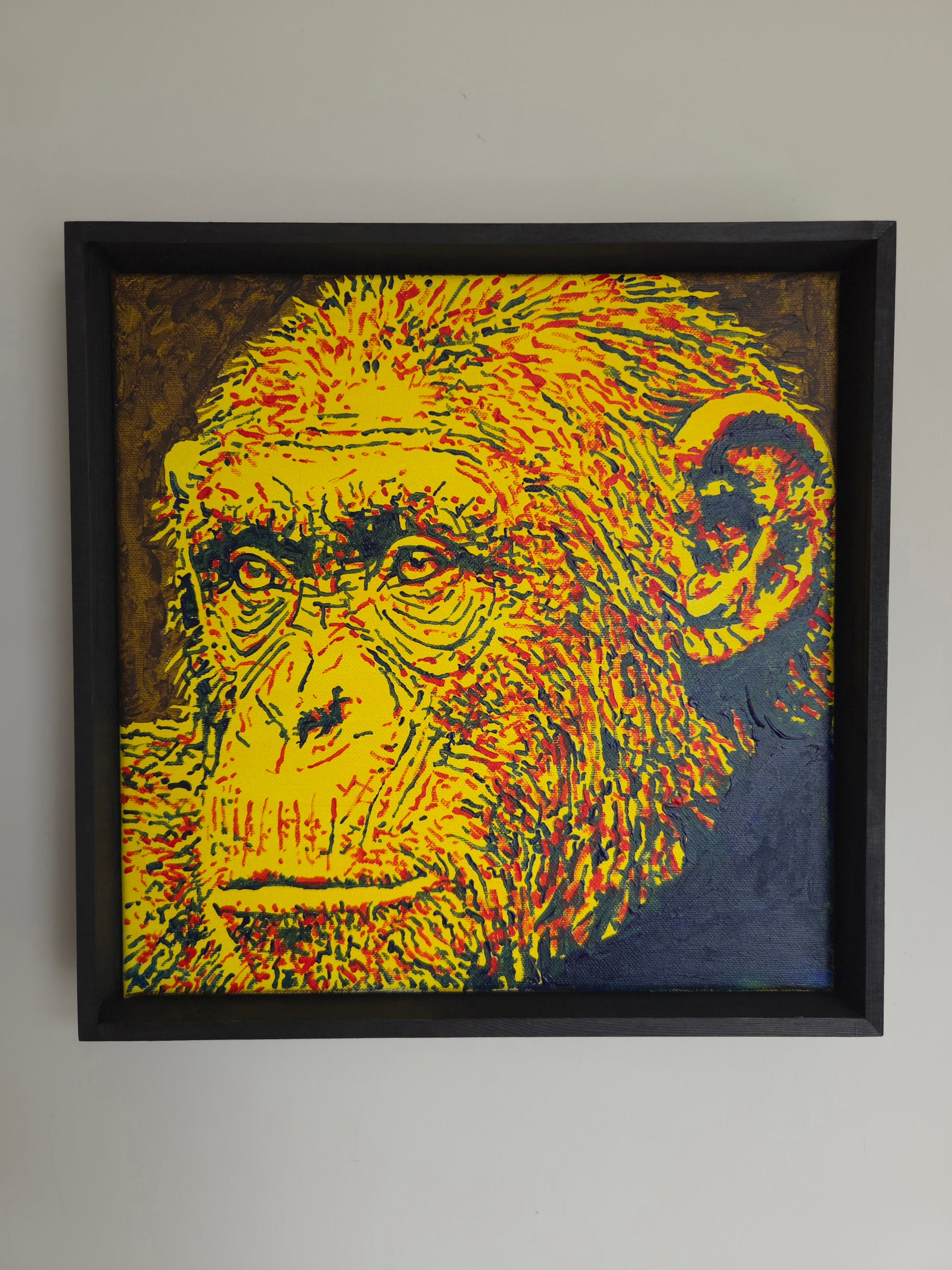 12 x 12 inch acrylic painting of a chimpanzee in red, yellow and blue. 